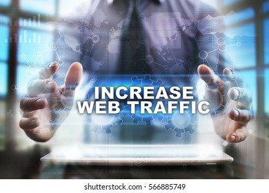 Businessman Using Tablet Pc And Selecting Increase Web Traffic.