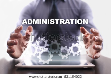Businessman is using tablet pc and selecting administration.