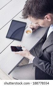 Businessman using tablet pc and smartphone.