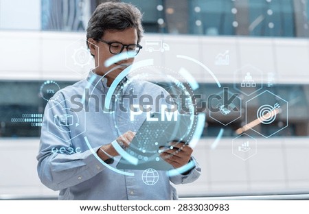 Businessman using a tablet with a PLM interface and glowing supply chain icons, photographic style, modern office background, planning concept