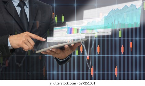 Businessman Using The Tablet Shown The Trading Graph Of Stock Market On The Virtual Screen Over The Trade Chart Background, Business Exchange Concept