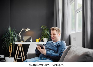     Businessman using tablet while sitting on sofa 