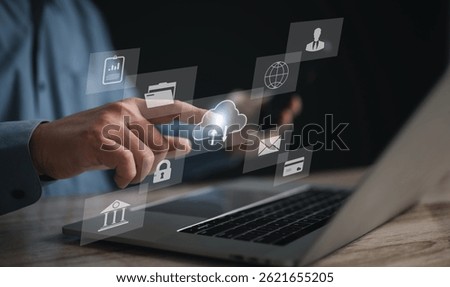 Businessman using touchscreen to interact with virtual dashboard displaying cloud, email, and e-commerce icons, symbolizing modern business solutions