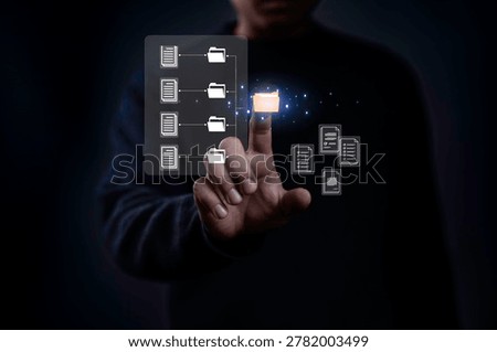 Businessman using virtual document management system interface with digital folders and files. Concept of data organization, cloud storage, cybersecurity and digital transformation technology.