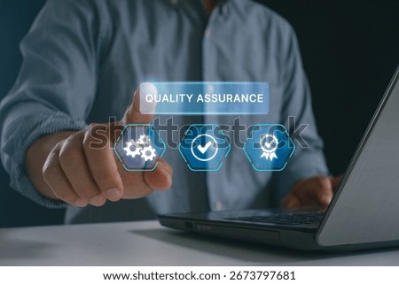 Businessman using virtual interface for quality assurance, demonstrating modern technology in quality control, management and software testing for industry standards compliance. ISO certification.