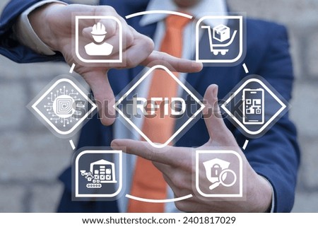 Businessman using virtual interface sees text: RFID. Radio Frequency Identification ( RFID ) Business Industry Communication Shopping Digital Technology Concept.