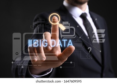 Businessman using virtual screen on dark background, closeup. Concept of data protection