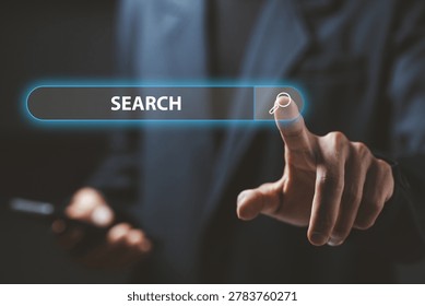 Businessman using virtual search interface with glowing search bar icon, representing online browsing, internet search engine and digital technology innovation concept.