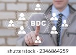 Businessman using virtual touch screen presses abbreviation: BDC. Concept of BDC Business Development Company.