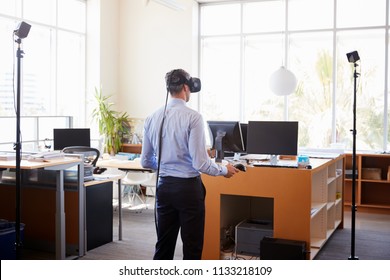 Businessman using VR technology in an office, back view - Powered by Shutterstock