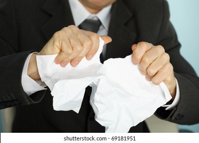 Businessman violently tormented the paper in his hands