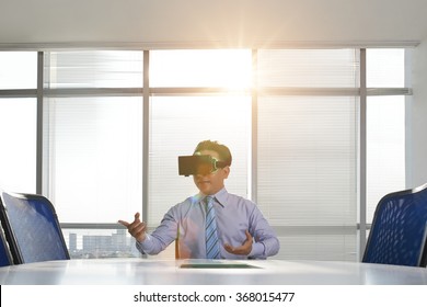 Businessman In Virtual Reality Goggles Holding Business Meeting In The Office