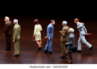 A Businessman Walking Against Crowd.