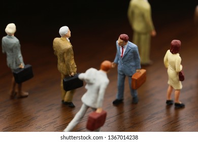 A Businessman Walking Against Crowd.