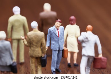 A Businessman Walking Against Crowd.