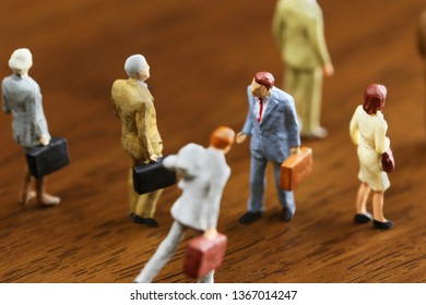 A Businessman Walking Against Crowd.