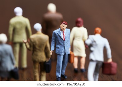 A Businessman Walking Against Crowd.