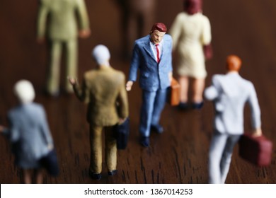 A Businessman Walking Against Crowd.