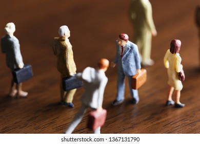 A Businessman Walking Against Crowd.