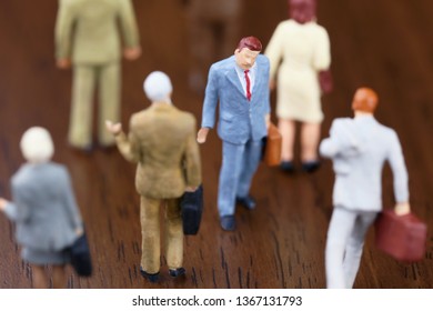 A Businessman Walking Against Crowd.