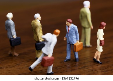 A Businessman Walking Against Crowd.