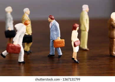 A Businessman Walking Against Crowd.