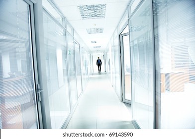 A Businessman Walking In The Office Corridor