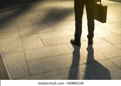 Businessman Walking On City, Focus To Foot Walk Step, Abstract Business Concept, Copy Space On Left Side.