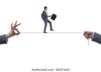 Businessman Walking On Tight Rope In Business Concept