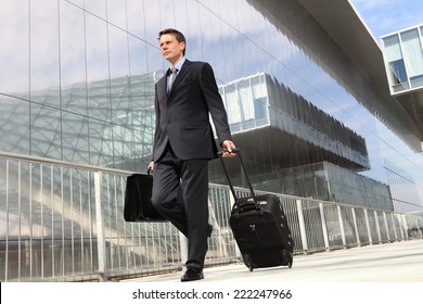 businessman walking with trolley and bag, business travel - Powered by Shutterstock