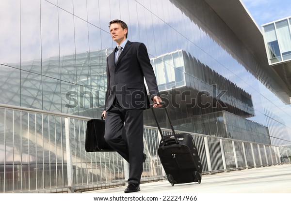 businessman walking with trolley and bag, business travel