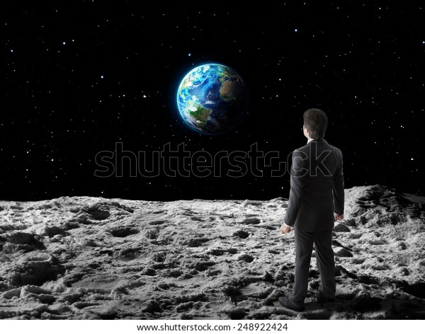 businessman walks  on moon\
surface\
