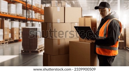 Businessman in warehouse. Distribution center supervisor. Businessman near cardboard boxes. Fulfillment manager with laptop. Businessman warehouse owner. Man in orange vest. Guy in warehouse building