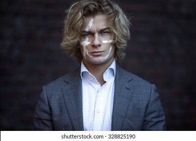 Businessman Warrior. Young Man Makes War Paint On His Face, Concept