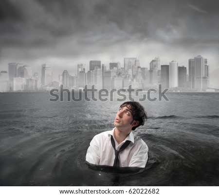 Businessman in the water with cityscape under stormy sky on the background