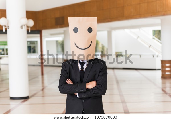 businessman\
wear paper bag covering head happy emotions\
