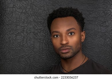 businessman wearing black t-shirt isolated portrait on leather background successful man in his twenties head shot