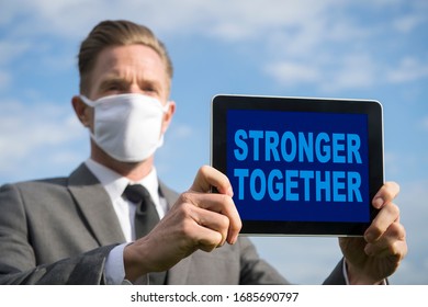 Businessman Wearing Coronavirus Protective Surgical Face Mask Holding A Tablet With A Motivational Stronger Together Message