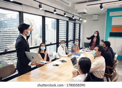 Businessman Wearing Face Mask Presentation Of Business Plan With Laptop And Corporate Business Meeting In Modern Office. During In Pandemic Of Virus