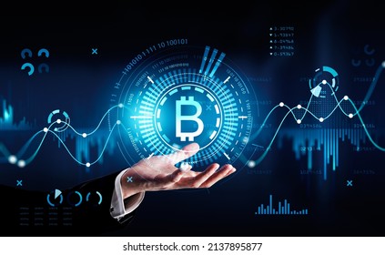 Businessman Wearing Formal Suit Is Holding Digital Interface With Bitcoin Cryptocurrency Icon With Binary Code, Bar And Pie Diagrams In The Foreground. Concept Of International Internet Trading