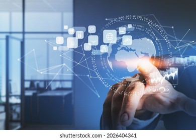 Businessman wearing formal suit is touching a digital interface with globe, cloud data, padlock, coin icons. Blurred office in the background. Concept of international business and communication