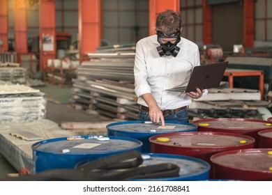 businessman wearing a mask to prevent toxic chemicals enters a warehouse in a factory for flammable hazardous substances. - Shutterstock ID 2161708841