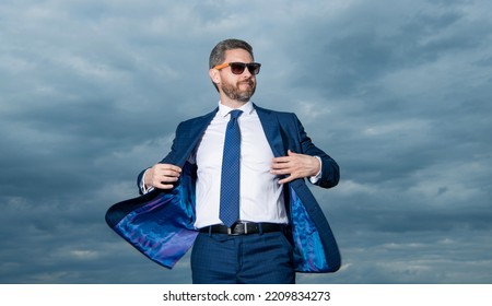 Businessman Wearing Open Suit Jacket Fluttering In Wind Sky Background