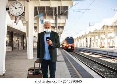 A businessman wearing protective face mask waiting for the train. A man on the train station wearing protective face mask. - Powered by Shutterstock