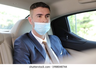 Businessman Wearing Protective Mask Incorrectly In Backseat