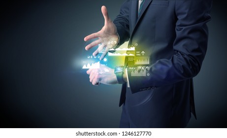 Businessman wearing smartwatch with graphics and charts on it. Stock Photo