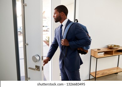 Businessman Wearing Suit Opening Door Leaving Home For Work