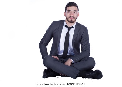 Businessman Wearing A Suit, Sitting Crossed Legs On The Floor, Isolated On White Background.