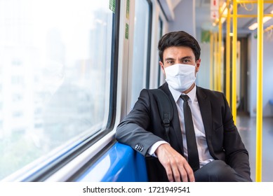 Businessman Wearing White Facial Mask During Travel By Train Sit Near Window, New Normal Life Style During Covid-19 Pandemic With No People On Train