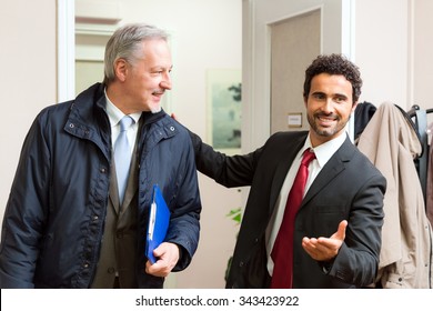 Businessman welcoming another businessman in his office